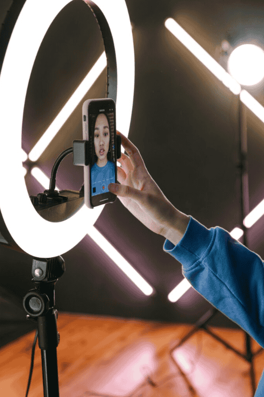 Woman using a ring light for a video shoot, showcasing influencer marketing agency services in Chandigarh.