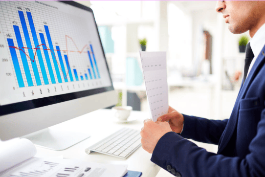Professional analyzing content performance graphs on a computer screen, representing a content marketing agency in Chandigarh.