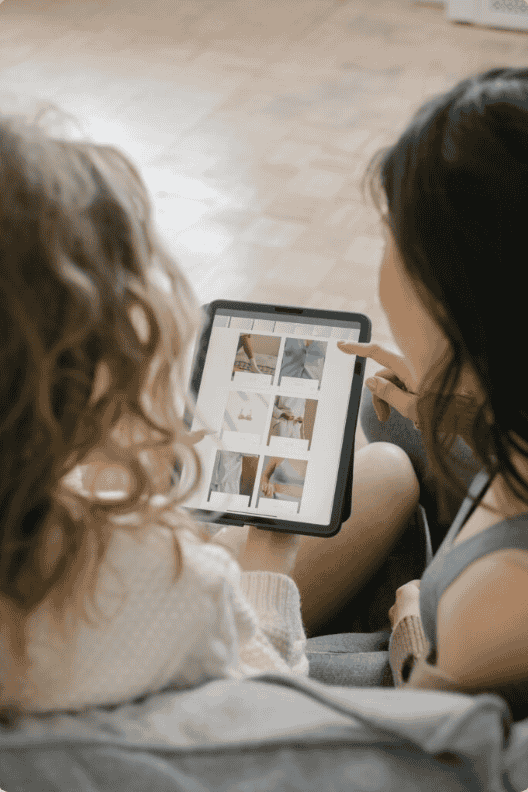 Two women browsing products on a tablet, showcasing services by an ecommerce marketing agency in Chandigarh